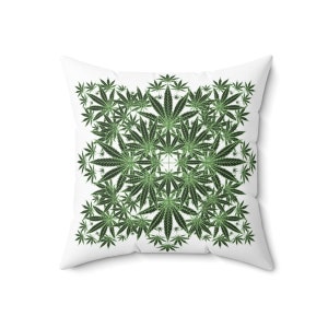 May include: White throw pillow with a green marijuana leaf pattern. The leaves are arranged in a symmetrical design.