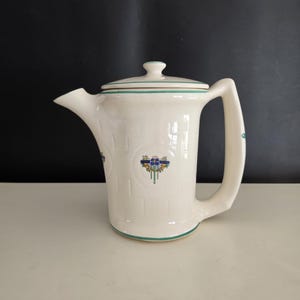 May include: A set of three ceramic nesting bowls in shades of blue, green, and white. The bowls feature a speckled glaze and a simple, modern design. The largest bowl measures approximately 6 inches in diameter.