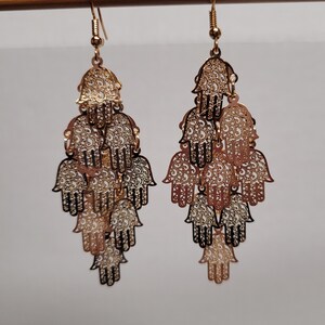 Layered gold hand of God dangle earrings