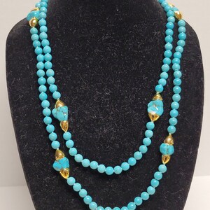 Lange 20 in turquoise en vergulde ketting