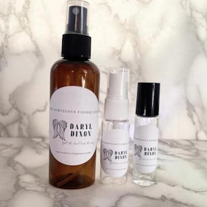 May include: Three glass bottles with spray tops and roll-on applicator. The bottles are labeled with the text "Daryl Dixon" and a pair of angel wings.
