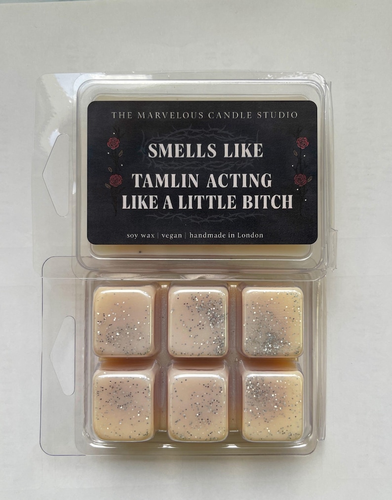 Puede incluir: Un envase transparente de pl&aacute;stico con seis ceras perfumadas. Cada cera es de forma cuadrada, de color melocot&oacute;n claro y con purpurina plateada. La etiqueta dice "THE MARVELOUS CANDLE STUDIO" y "SMELLS LIKE TAMLIN ACTING LIKE A LITTLE BITCH."