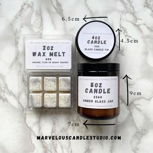 May include: A set of three candles in different sizes and styles. The largest candle is an 8 ounce amber glass jar candle. The medium candle is a 4 ounce black tin candle. The smallest candle is a 2 ounce wax melt in a clear plastic container with six individual wax melts. The candles are all from The Marvelous Candle Studio.