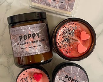 May include: An assortment of scented candles and wax melts from The Marvelous Candle Studio. The products feature the "Poppy" fragrance, with labels reading "The Maiden Turned Queen." The candles are in various containers, including a jar and tins, with decorative elements.