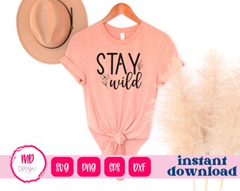 May include: A peach-colored t-shirt with the text "Stay Wild" in black lettering. The shirt has a floral design and is tied in a knot at the bottom.