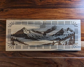 Bald Eagle flying over a valley with mountains, 3 Track Cribbage Board - Laser engraved