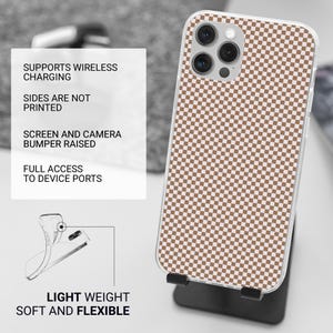 May include: A clear phone case with a brown and white checkered pattern. The case is displayed on a black stand. Text on the left side reads: Supports Wireless Charging, Sides Are Not Printed, Screen and Camera Bumper Raised, Full Access to Device Ports, Light Weight, Soft and Flexible.