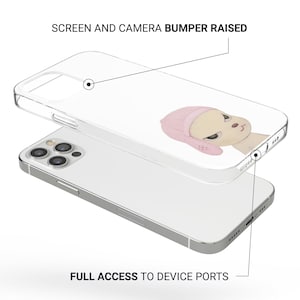 May include: Clear phone case with a cartoon illustration of a beige character wearing a pink hat. The case is designed to protect the screen and camera, with full access to device ports.