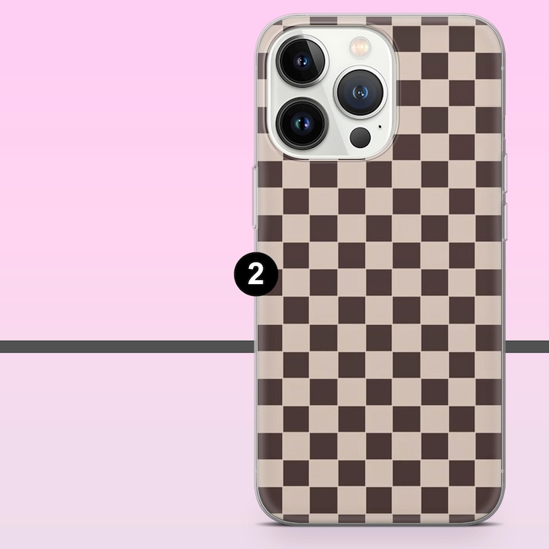 May include: A phone case with a brown and beige checkerboard pattern. The case has a clear border and features the camera lenses and flash of the phone. The number "2" is printed on the case.