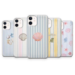 May include: A collection of phone cases with beach-themed designs. Each case features a different design, including seashells, seahorses, and beach umbrellas. The cases have a striped background in various colors, including blue, pink, and yellow.