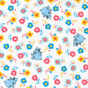 May include: White fabric with a repeating pattern of blue elephants, yellow, pink, and blue flowers. The elephants are in a walking position with their trunks raised.