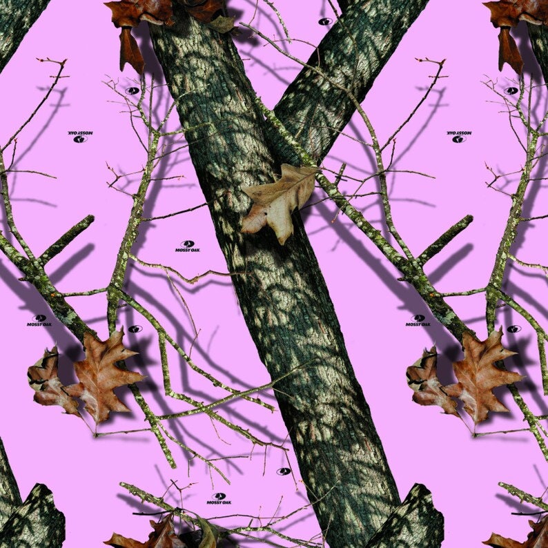 May include: Pink camouflage pattern with brown tree branches and leaves. The pattern features the words "Mossy Oak" and "T.V.O. Jason" repeated throughout.