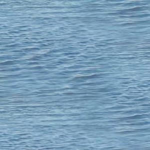 May include: A seamless, abstract image of the ocean's surface. The water is a light blue color, with gentle waves creating a textured pattern across the entire frame. The image evokes a sense of calm and tranquility.