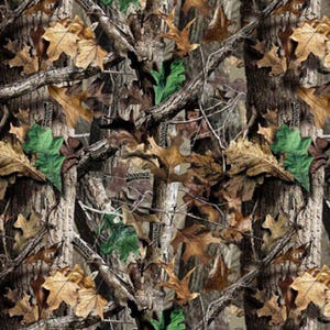 May include: Camouflage pattern featuring a blend of brown, green, and tan hues, mimicking a forest environment. The design incorporates tree bark, branches, and various leaf types, including oak leaves. The word "ADVANTAGE" is visible in the pattern.