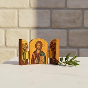 Jesus Christ Pantocrator triptych icon with Archangels Michael and Gabriel, handcrafted olive wood icon from Nazareth Holy Land. On a altar setting