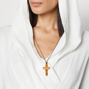 Olive Wood Cross Necklace, Handcrafted in Nazareth. Minimalist Pendant. Christian necklace on woman model background.