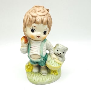 Charming Vintage Boy Figurine with Apple and Furry Companion