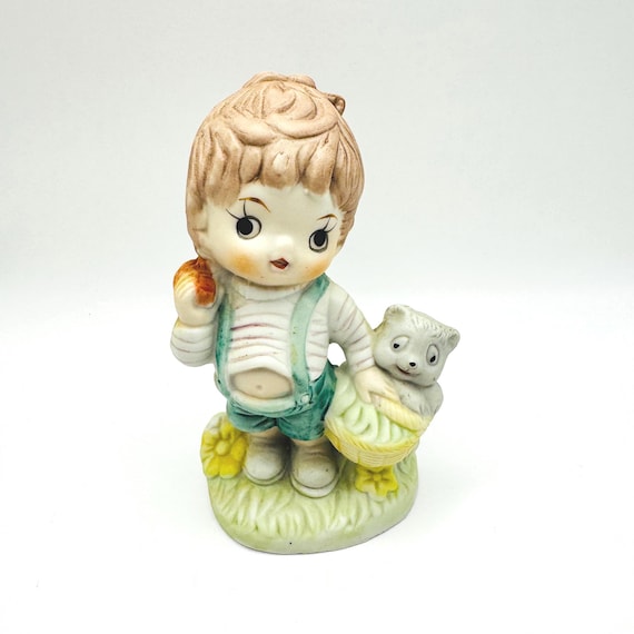 Charming Vintage Boy Figurine with Apple and Furry Companion