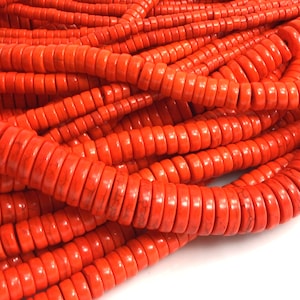 May include: A strand of bright orange round beads made of natural stone. The beads are smooth and polished, with a slightly irregular shape. The beads are strung on a clear thread and are ready to be used for jewelry making.