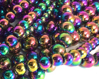 May include: A strand of iridescent rainbow colored beads. The beads are round and smooth, and they have a metallic sheen. The beads are strung on a clear thread.