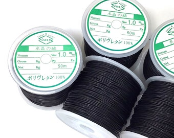 May include: Four spools of black elastic cord, each with a label that reads "Water's Line" in Japanese characters. The label also includes the text "Size 1.0 mm", "Ply 50m", and "Polyurethane 100%".