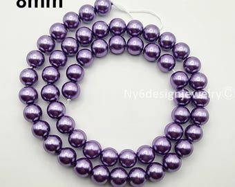 May include: Strand of 8mm purple beads. The beads are a deep, lustrous purple color and are strung together on a white string. The image includes the text "8mm" in the upper left corner and "Ny6designjewelry©" in the lower right corner.