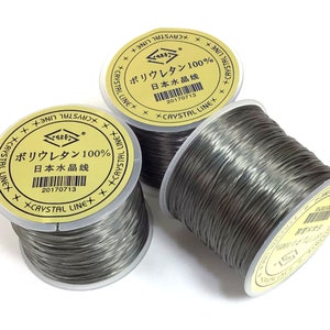 May include: Three spools of gray fishing line with yellow labels that read "Crystal Line" and "Polyurethane 100% Japanese Water Line" with the product code 20170713.