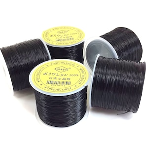 May include: Five spools of black elastic string, each with a yellow label that reads "Polyurethane 100% Japanese Crystal Line" in Japanese and English.