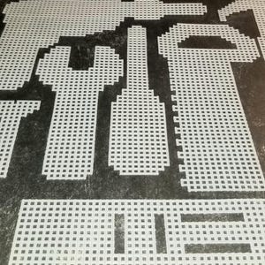 May include: White plastic canvas sheets with various shapes cut out. The shapes include a rectangle, a square, and a long, thin rectangle. The canvas is designed for cross-stitch or other needlework projects.