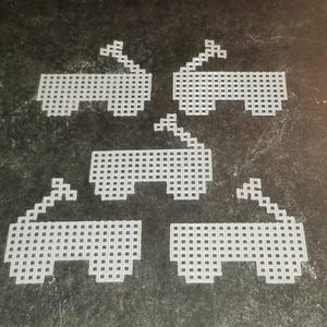 May include: Five white plastic frames with a grid pattern. The frames are arranged in a star shape.