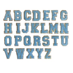 May include: A complete set of twenty-six alphabet letters from A to Z, rendered in a light blue, textured, glittery finish with a gold-toned border. Each letter features a classic block-style varsity font, arranged in four rows against a white background.