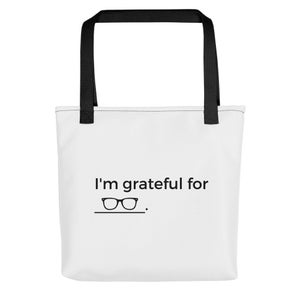 May include: White tote bag with black handles and the text "I'm grateful for" with a pair of glasses underneath.