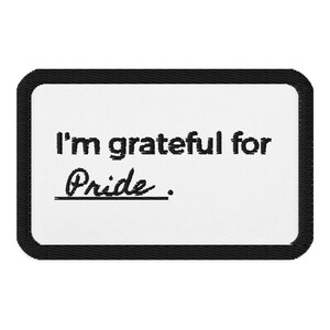 May include: White rectangular patch with black border and text that reads "I'm grateful for Pride."