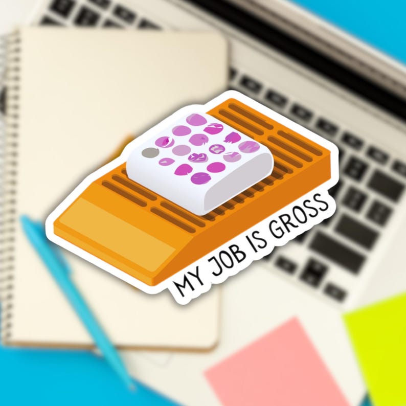 May include: A sticker with a white square with pink circles on top of a yellow ramp. The text "MY JOB IS GROSS" is written on the sticker.