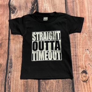 May include: Black t-shirt with a silver graphic that says "STRAIGHT OUTTA TIMEOUT".