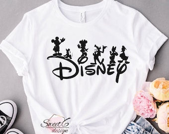 May include: White t-shirt featuring a black Disney logo with Mickey Mouse, Minnie Mouse, Pluto, Donald Duck, and Goofy silhouettes. The shirt has a crew neck and short sleeves. The text "Disney" is printed in a stylized font.