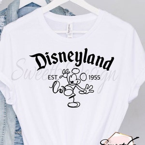 May include: White t-shirt with a black graphic of Mickey Mouse and the text "Disneyland Est. 1955".