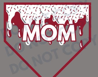 May include: A white baseball-shaped design with red dripping icing and white sprinkles. The word "MOM" is written in white letters on the design.