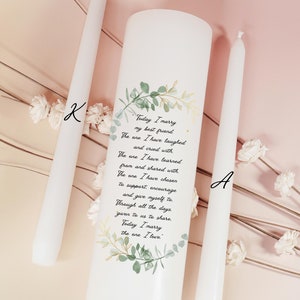 May include: Two white wedding unity candles with a green floral design and text that reads "Today I marry my best friend. The one I have laughed and cried with. The one I have learned from and shared with. The one I have chosen to support, encourage, and give myself to. Through all the days given to us to share. Today I marry the one I love."