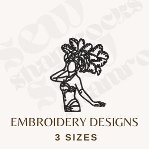 May include: Black line art of a woman in a feathered headdress and costume. The text "EMBROIDERY DESIGNS" and "3 SIZES" are below the image. This design is suitable for embroidery projects.