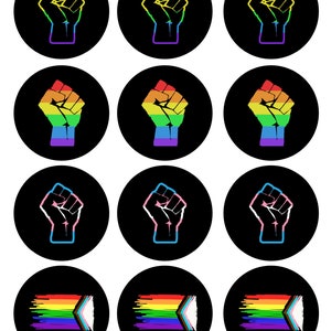 May include: Twelve round stickers with a black background. Six stickers feature a raised fist with a rainbow color scheme. Three stickers feature a raised fist with a transgender pride flag color scheme. Three stickers feature a rainbow pride flag with a white chevron.