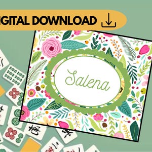 May include: A floral design with the name "Salena" in a green oval frame. The design is surrounded by pink roses, green leaves, and other colorful flowers. The words "DIGITAL DOWNLOAD" are in a yellow banner.