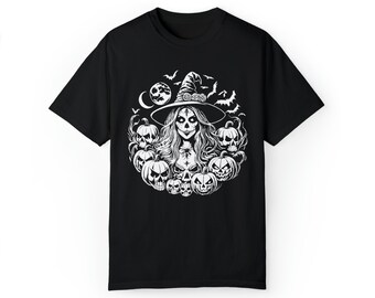 May include: Black t-shirt with a white graphic of a witch with skull makeup, surrounded by pumpkins, bats, and a moon. The witch wears a pointed hat with the word "BOSS" on it. A spooky design perfect for Halloween.