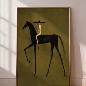 May include: A framed wall art print featuring a stylized illustration of a tall, slender figure wearing a wide-brimmed black hat and riding a long-legged black horse. The background is a solid olive green, and the figure wears a single red boot.