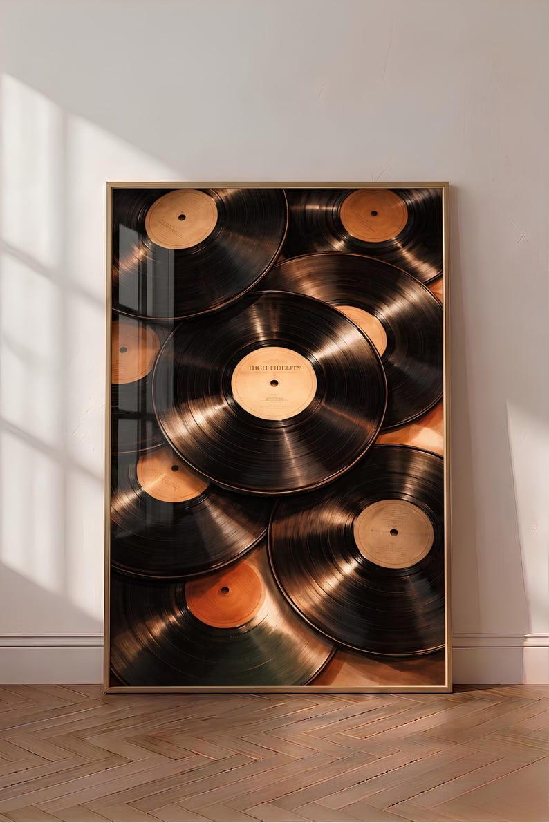 May include: A framed vertical wall art print featuring a collage of overlapping black vinyl records with tan center labels. The central record prominently displays the text "HIGH FIDELITY" printed in black on its tan circular label.