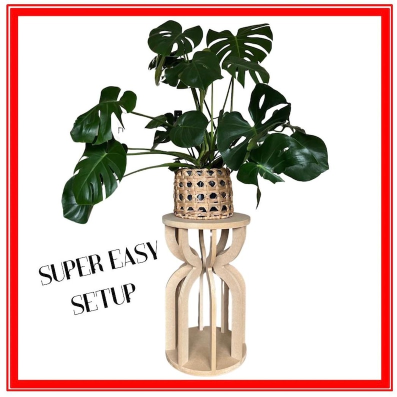 May include: A potted Monstera plant with large, green leaves sits on a light wood plant stand. The plant pot is woven with a natural fiber. The stand has a unique, open design. Text on the image reads "SUPER EASY SETUP".