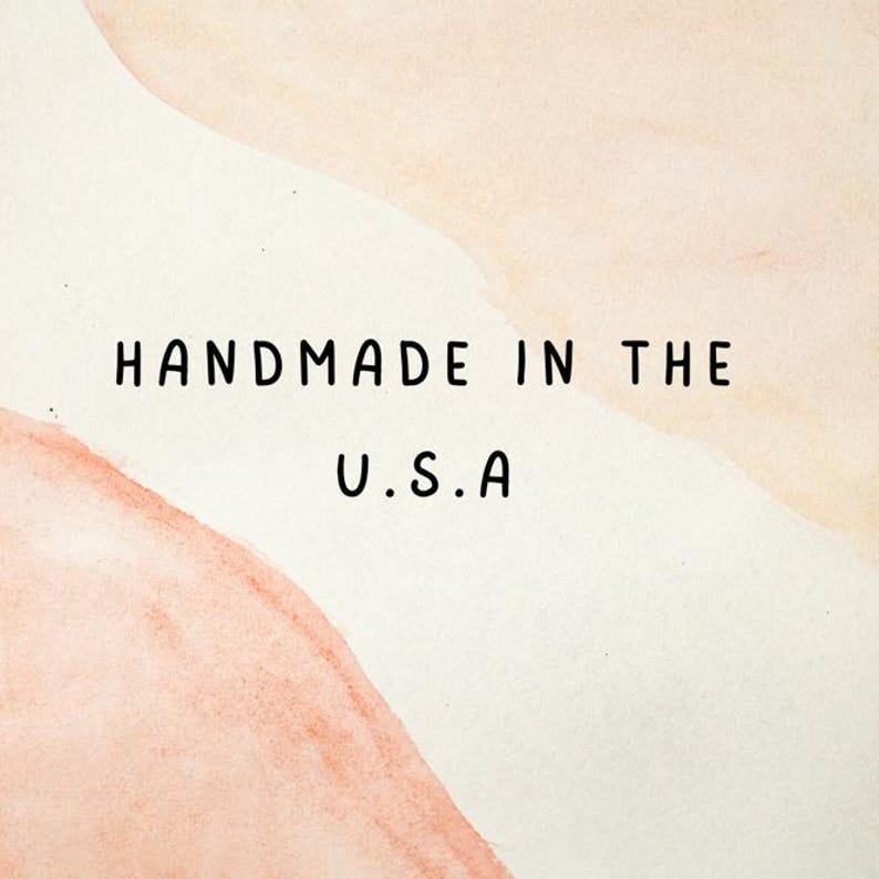 May include: A watercolor-style background with soft peach and cream tones. The text "HANDMADE IN THE U.S.A" is centered in black, sans-serif font.