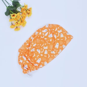 Halloween Boo Ghosts on Orange Ponytail Scrub Cap for Women with Ties Elastic Pouch Spooky Fall Horror Surgical Hat, Satin lined Scrub Cap