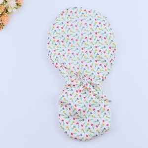Small flowers on ivory Ponytail scrub cap, Surgical cap women. Satin Lined Option Surgical cap with ponytail. Satin lined scrub cap.