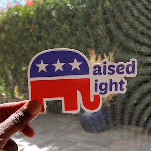 May include: A blue and red elephant sticker with three white stars and the text "raised right".